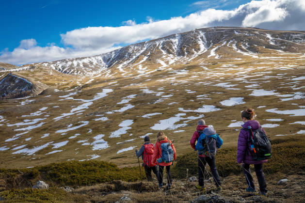 Hikers on a mountain trail. Guarcino (FR), Italy - December 21, 2025: A group of hikers in single file walk along a mountain trail, with the partially snow-capped peaks of the Lazio Apennines in the background. Guarcino FR Italy Copyright: xGennaroxLeonardix