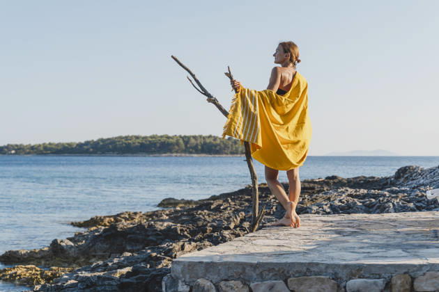 Woman enjoying summer vacation on seaside rocky beach in nature model released, Symbolfoto, NDEF03188