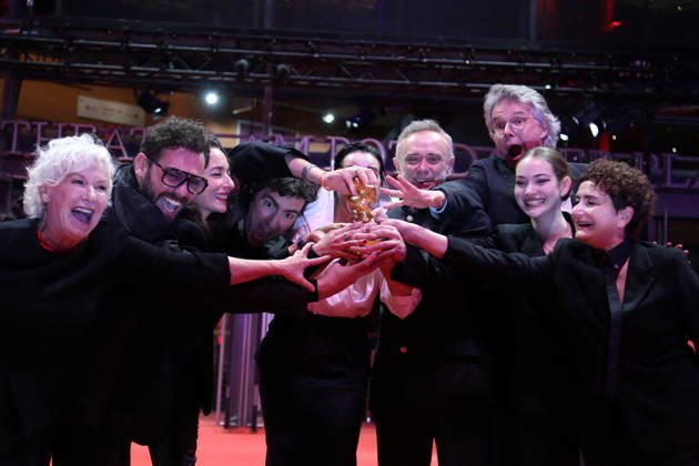 February 21, 2026, Berlin, Germany: Ilker Catak, with cast and crew pose with the Golden Bear for Best Film for Gelbe Briefe (Yellow Letters) after the closing ceremony of the 76th Berlin International Film Festival (Berlinale), Europe s first major film festival of the year, in Berlin. The festival runs from February 12 to 22, 2026. Berlin Germany - ZUMAf146 20260221_zip_f146_015 Copyright: xRouzbehxFouladix