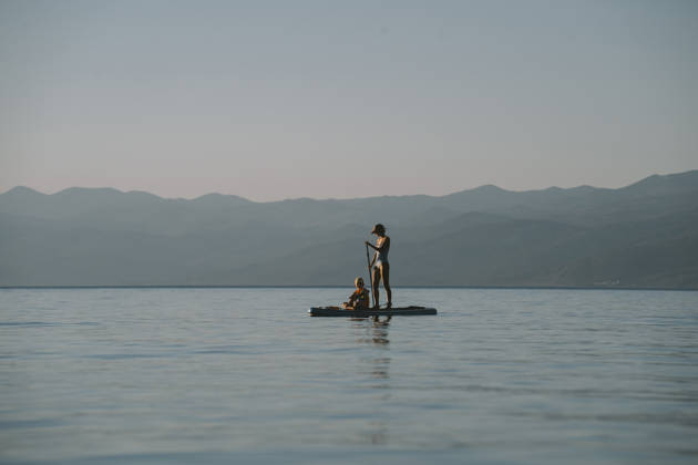 Family paddling on paddleboard against tranquil seascape in summer model released, Symbolfoto, NDEF03221