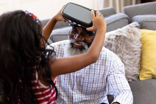 Senior African American man and his granddaughter Using vr headset Senior African American man and his granddaughter enjoying their time at home together, sitting on a couch, wearing a VR headset, model released, , property released, Cape Town, South Africa, 19.02.2020, 1340098.jpg, people,family,grandfather,granddad,granddaughter,childhood,together,closeness,interacting,sitting,couch,happy,smiling,wearing,using,vr,virtual reality,headset,connection,communication,real people,home,house,domestic life,lifestyle,enjoying,free time,leisure,relaxing,weekend,summer,sunny,love Child,Girl,Female,Mixed-Race,Mid Adult,Man,Male,Black Indoors,Front view,Looking at camera,Day,Half length