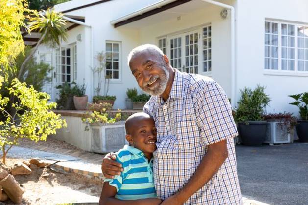 Senior African American man and his grandson spending time together in their garden on a sunny day Senior African American man and his grandson spending time together in their garden on a sunny day, smiling and looking straight into a camera., model released, , property released, Cape Town, South Africa, 24.01.2020, 1352225.jpg, people,real people,home,domestic life,lifestyle,free time,leisure,relaxing,happy,enjoying,smiling,summer,garden,backyard,sunny,hobby,heathy,nature,heathy lifestyle,active seniors,retirement,interacting,togetherness,closeness,grandfather,grandson,playing,fun,embracing,hugging,portrait Child,Boy,Male,Black,Senior,Elderly,Man,Mixed-Race Outdoors,Front view,Focus on Foreground,Looking at camera,Two objects,Day,Half len