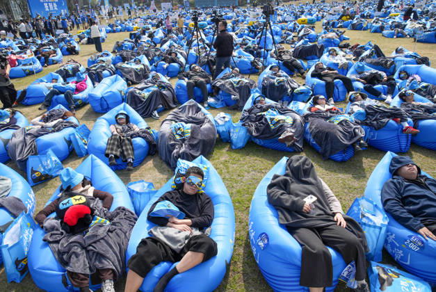 DEQING, CHINA - MARCH 21: Participants fall asleep on the outdoor lawn in the Sleep King challenge to mark World Sleep Day on March 21, 2026 in Deqing County, Huzhou City, Zhejiang Province of China.  Copyright: xVCGx 111629755092