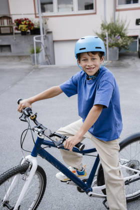 Happy child outdoors riding bike with helmet smiling model released, Symbolfoto property released, KNSF12346