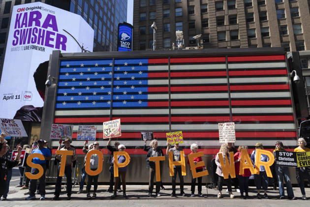 April 4, 2026, New York, New York, USA: Demonstrators join Rise and ResistÃ¢â‚¬â ¢s anti-war protest under the Times Square US Army Recruiting Station American flag, calling for an end to the war on Iran and denouncing President Trump and Secretary of Defense Hegseth as war criminals. Protesters chant holding letters that spell out Ã¢â‚¬ËœSTOP THE WAR,Ã¢â‚¬â ¢ and signs that read NOPE TO YOUR FAUX KING WARS NO WAR ON IRAN STOP Christian Nationalists. New York USA - ZUMAr174 20260404_znp_r174_016 Copyright: xGinaxMxRandazzox