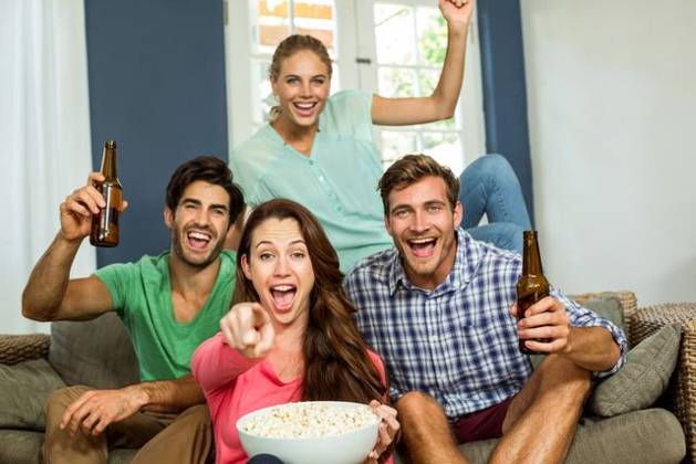Portrait of smiling friends enjoying party Portrait of smiling happy friends enjoying party at home, model released, , property released, Cape Town, South Africa, 08.12.2015, 706145.jpg, beautiful, lifestyle, leisure, sitting, pretty, attractive, looking, beautiful woman, home, homey, household, apartment, domicile, casual clothing, relaxing, beauty, house, abode, friends, friendship, causal, togetherness, living room, sitting room, handsome, smart, enjoying, arms raised, bowl, food, drink, bottle, holding, refreshment, beer, casual, couch, fun, group, laughing, party, screaming, shouting, smiling, sofa, alcohol, door, happiness, cheerful, joyful Indoors,Front view,Portrait,Looking at camera,Day,Three Quarter Length