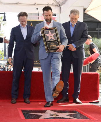 American actor, director and writer Noah Wyle steps on his star during an unveiling ceremony honoring him with the 2,840th star on the Hollywood Walk of Fame in Los Angeles on Thursday, April 9, 2026. Looking on are actors Steven Weber (L) and Jonathan Frakes. LAP20260409901 JIMxRUYMEN