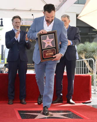 American actor, director and writer Noah Wyle steps on his star during an unveiling ceremony honoring him with the 2,840th star on the Hollywood Walk of Fame in Los Angeles on Thursday, April 9, 2026. Looking on are actors Steven Weber (L) and Jonathan Frakes. LAP20260409902 JIMxRUYMEN