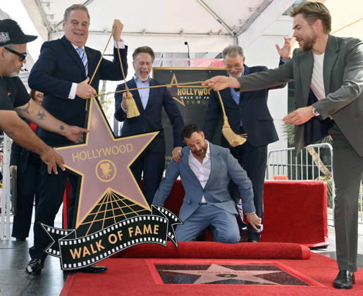 American actor, director Noah Wyle (kneeling) reacts during an unveiling ceremony honoring him with the 2,840th star on the Hollywood Walk of Fame in Los Angeles on Thursday, April 9, 2026.  LAP20260409903 JIMxRUYMEN