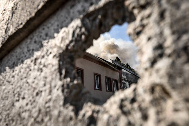 A hole frames rescuers use a telescopic ladder to extinguish a fire in an office building caused by a Russian drone strike in Zaporizhzhia, Ukraine, April 13, 2026. The Russian attack also damaged industrial enterprises and nearby residential buildings. (Photo by Dmytro Smolienko Ukrinform) Russian drone hits office building in Zaporizhzhia  Copyright: xDmytroxSmolienkox