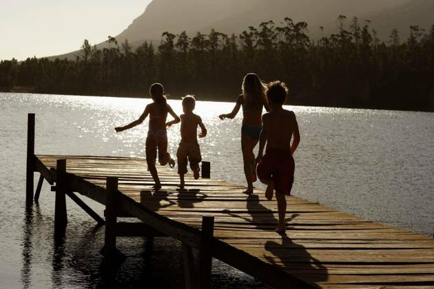 Children Running On Jetty At Lake - Rear view of young boys and girls running on jetty at lake model released Symbolfoto Copyright: xmoodboardx Panthermedia75390914.jpg