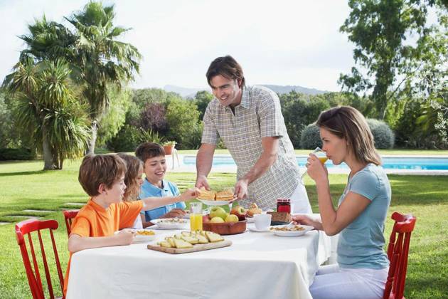 Family Sitting At Outdoor Breakfast Table - Couple with three children sitting at breakfast table outdoors model released Symbolfoto Copyright: xmoodboardx Panthermedia75392464.jpg