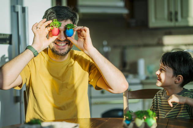 Father and son playing with Easter egg microgreens in kitchen model released, Symbolfoto property released, ANAF05726
