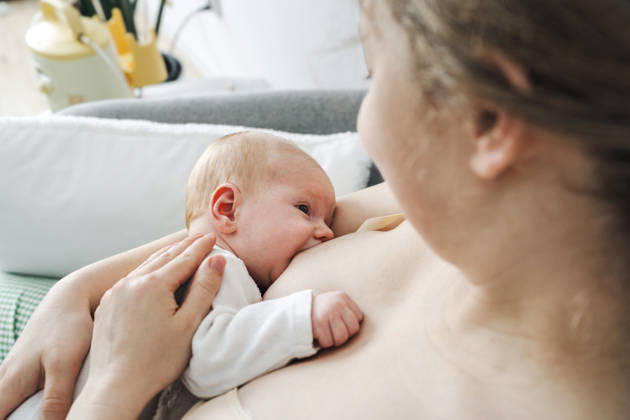 Mother breastfeeding her newborn baby indoors model released, Symbolfoto property released, NSTF00619