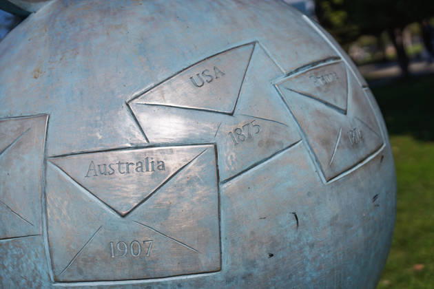 Batumi, georgia 21 april 2026: bronze globe sculpture depicting envelopes and dates representing global post history, creating a symbol for communication and connection Metal globe sculpture showing international communication Copyright: xx Batumi Edit 509