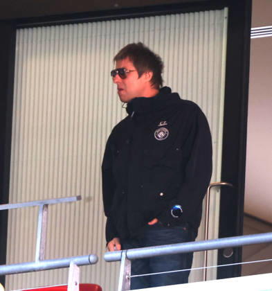 Liam Gallagher with what looks like a vape in his hand at the Emirates FA Cup Semi-Final match Manchester City v Southampton, at Wembley Stadium, London, UK on 25th April, 2026. 