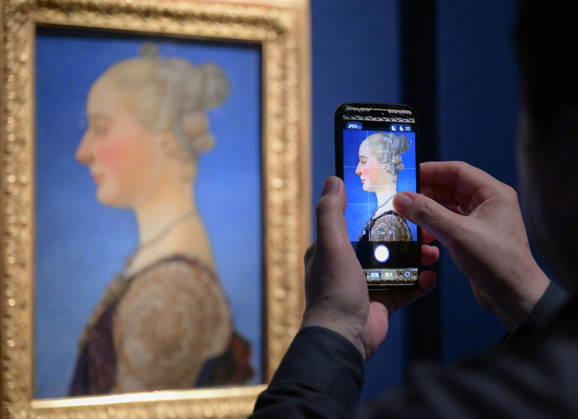 (260427) -- BEIJING, April 27, 2026 -- A visitor takes photos of an art work during an exhibition in Beijing, capital of China, April 27, 2026. An art exhibition Homage to the Virtuosos: From Leonardo da Vinci to Caravaggio -- Masterpieces of the Italian Renaissance opens to the public here on Monday. This exhibition displays 36 masterpieces by more than 20 renowned Italian artists from the 15th to the 17th centuries, including Botticelli, da Vinci, Michelangelo, and Raphael. Most of the works are on display in China for the first time. ) CHINA-BEIJING-ITALIAN RENAISSANCE-EXHIBITION (CN) LixHe 