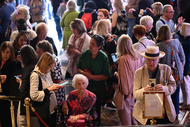 OPERA AUSTRALIA 70TH ANNIVERSARY, Guests use a QR code to view tickets after Australian soprano Stacey Alleaume and Tongan tenor Filipe Manu performed for the public as part of Opera Australia™s 70th anniversary at the on the steps of the Regent Theatre in Melbourne, Wednesday, April 29, 2026. ( NO ARCHIVING MELBOURNE VICTORIA AUSTRALIA  Copyright: xJOELxCARRETTx 20260429147040220013
