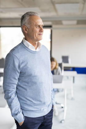 Thoughtful businessman standing with hands in pockets at office model released, Symbolfoto property released, MIKF00664