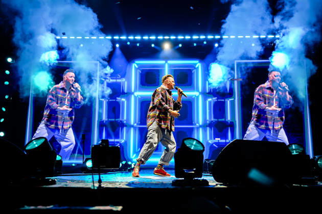 Ben Zucker performt mit Mikrofon vor einer beleuchteten Bühne mit blauen Lichteffekten und Nebel bei der Schlagernacht des Jahres 2026. Köln, Lanxess Arena, 09.05.2026 NRW DE