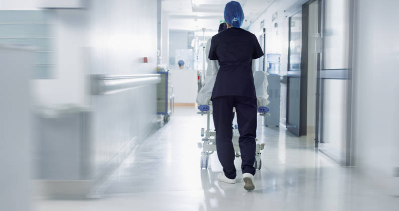 Patient, bed and nurse walking in hospital, hallway or corridor to surgery, operation room or ER healthcare service. Doctor, moving and pushing person in clinic to ICU, bedroom or walk with support. (License=RF) ,model released, Symbolfoto Copyright: xZoonar.com YurixArcursxpeopleimages.comx 21235874 ,model released, Symbolfoto ,property released