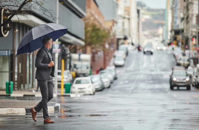 Walking, city and businessman with umbrella for rain in morning commute, travel and journey to office in winter. Professional, corporate and person in urban town for career, job and work in New York. (License=RF) ,model released, Symbolfoto  Copyright: xZoonar.com YurixArcursxpeopleimages.comx 21829019 ,model released, Symbolfoto ,property released