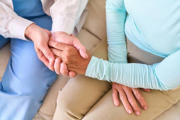 Senior healthcare support ? a compassionate nurse gently holds the hand of an elderly patient, offering comfort and medical assistance. (License=RF) ,model released, Symbolfoto  Copyright: xZoonar.com RobertxKneschkex 25011581 ,model released, Symbolfoto ,property released