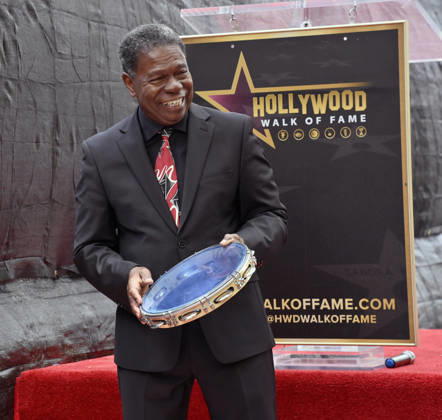 Brazilian percussionist Paulinho da Costa beats on a tambourine during an unveiling ceremony honoring him with the 2,844th star on the Hollywood Walk of Fame in Los Angeles on Wednesday, May 13, 2026.  LAP2026051309 JIMxRUYMEN