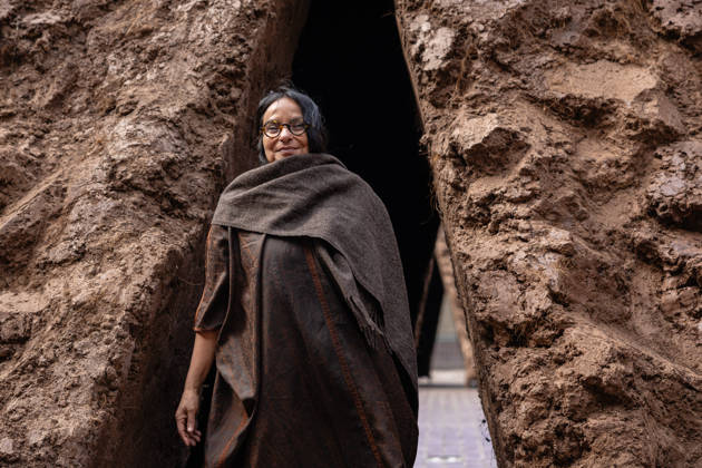 Delcy Morelos: origo at the Barbican Sculpture Court, London, UK 14 May 2026 Colombian artist Delcy Morelos poses with her sculpture origo at the Barbican Sculpture Court, London, UK, on 14 May 2026. The giant earthen sculpture spans roughly 24 x 18 metres and is hand-built with several tonnes of soil and aromatic spices including cinnamon and coffee, initially inspired by the architecture of the Yanomami people of the Amazon, on view from 15 May until 31 July 2026., Credit:Pete Speller Avalon  Copyright: xPetexSpellerx xAvalonx 1098917840
