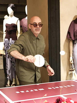 IPA84680220 - Rome, Laila Hasanovic attends the Antonio Marras boutique event. Pictured: Antonio Marras plays ping pong.  Copyright: xMarcoxProvvisionatox xMarcoxProvvisionatox 84680220