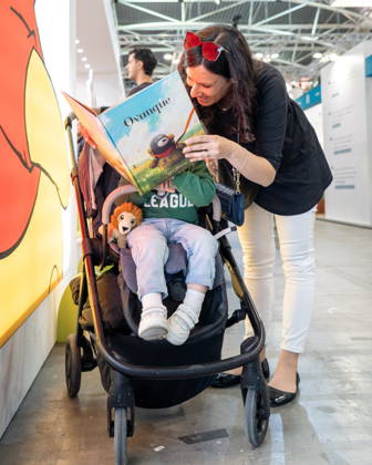 May 15, 2026, Turin, To, Italy: Some moments from the second day of the International Book Fair. Pictured is a mother reading a book to a little girl. Turin, May 15, 2026 Turin Italy  - ZUMAa289 20260515_zia_a289_015 Copyright: xSelenexDanielex xAgfx