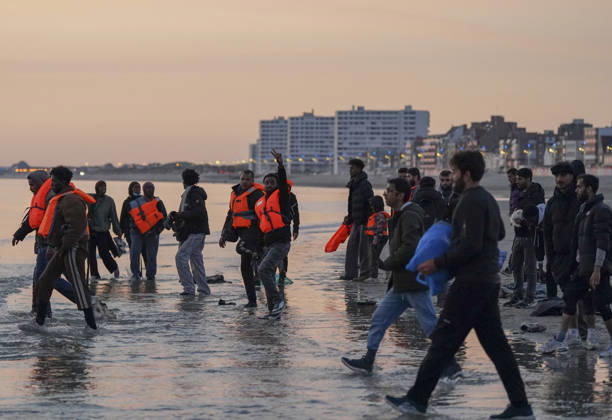 May 23, 2026, Dunkirk, Nord, France: Dunkirk, France. Migrants, most wearing life jackets, wait to board an inflatable boat at the beach at Dunkirk, while attempting to cross the English Channel. More than 200,000 migrants have crossed the Channel in small boats since 2018. Dunkirk France  - ZUMAl94_ 20260523_zaf_l94_028 Copyright: xIoannisxAlexopoulosx
