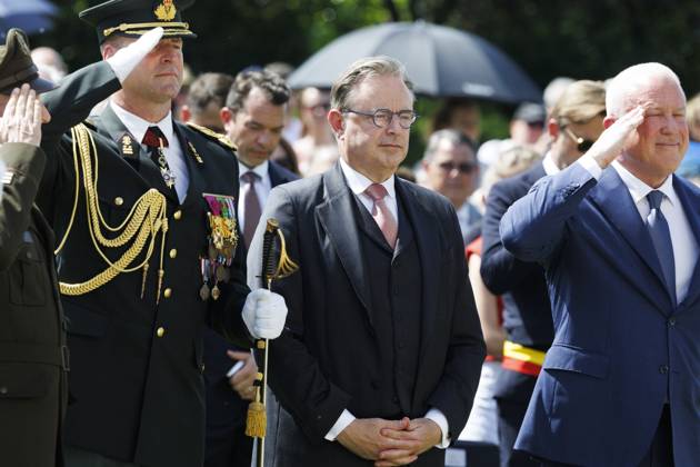 The representative of the King, Prime Minister Bart De Wever and US ambassador to Belgium Bill White pictured during the annual Memorial Day ceremony at the Flanders Field American Cemetery, in Waregem, Sunday 24 May 2026.  NICOLASxMAETERLINCK 174928955