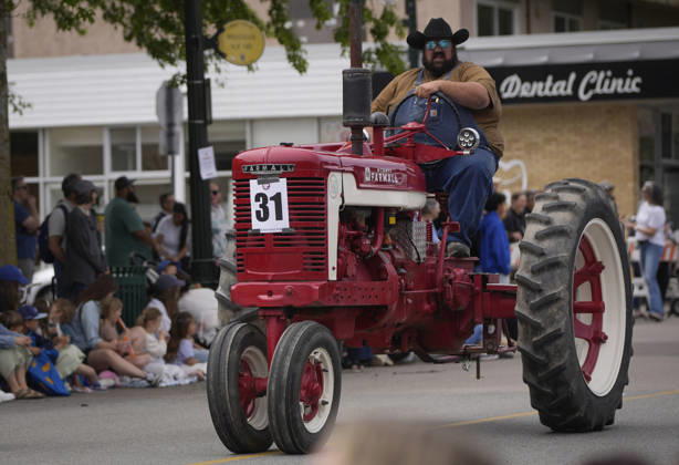 (260525) -- DELTA, May 25, 2026 -- A man drives a tractor on the street during the Ladner May Days parade in Ladner, British Columbia, Canada, May 24, 2026. (Photo by Xinhua) CANADA-BRITISH COLUMBIA-LADNER-MAY DAYS PARADE LiangxSen 