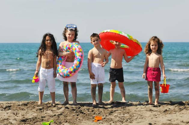 happy child group have fun on beach while playing with toys running jumping model released Symbolfoto Copyright: xdotshockx Panthermedia67488482.jpg
