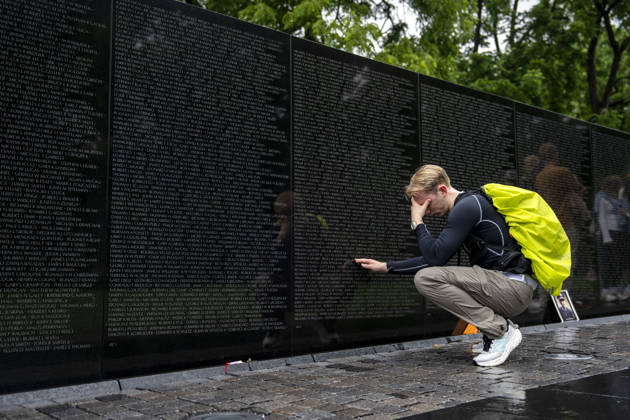 A man becomes emotional touching a name on the Vietnam Veterans Memorial on Memorial Day in Washington, DC on Monday, May 25, 2026.  WAP20260525309 BONNIExCASH