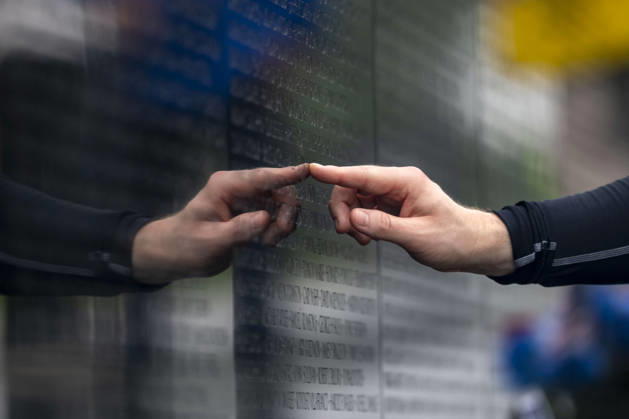 A man touches the a name on the Vietnam Veterans Memorial on Memorial Day in Washington, DC on Monday, May 25, 2026.  WAP20260525310 BONNIExCASH