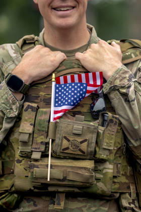 A member of the U.S. National Guard holds a flag in his vest while patrolling the Memorial Day Parade on Memorial Day in Washington, DC on Monday, May 25, 2026.  WAP20260525315 BONNIExCASH