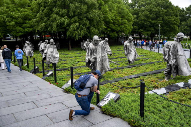 A man reads information about Prisoners of War and those Missing in Acton at the Korean War Memorial on Memorial Day in Washington, DC on Monday, May 25, 2026.  WAP20260525328 BONNIExCASH