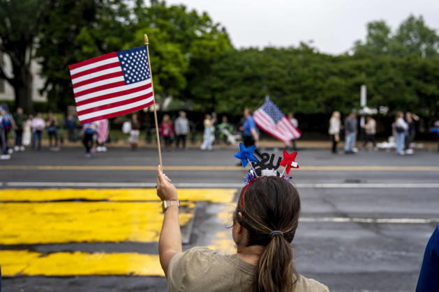A woman waves a U.S. flag as the Memorial Day Parade passes down Constitution Avenue on Memorial Day in Washington, DC on Monday, May 25, 2026.  WAP20260525334 BONNIExCASH
