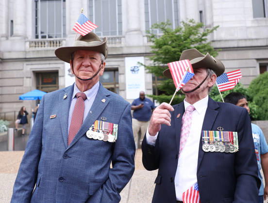 May 25, 2026, Washington, District Of Columbia, USA: Veterans with American flags watch the National Memorial Day Parade in Washington, DC, USA, on May 25, 2026. The parade has been held annually since 2005, marking its 21st anniversary. Washington USA - ZUMAs337 20260525_znp_s337_031 Copyright: xGentxShkullakux