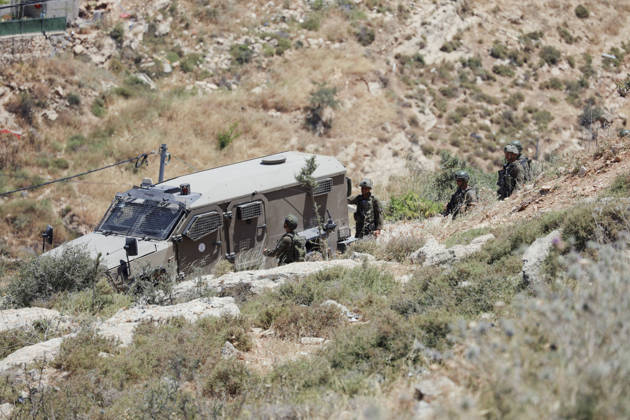 Israeli Demolition West Bank Family Displaced Eid Al-Adha Israeli soldiers gather near an Israeli military vehicle parked on a rocky hillside in Nahhalin, occupied West Bank, on May 25, 2026, after a demolition operation. The demolition, carried out by Israeli forces who stated the structure was built without a permit, displaced an eight-member Palestinian family just two days before the Islamic holiday of Eid al-Adha. Bethlehem West Bank Palestinian Territories Copyright: xMosabxShawerx