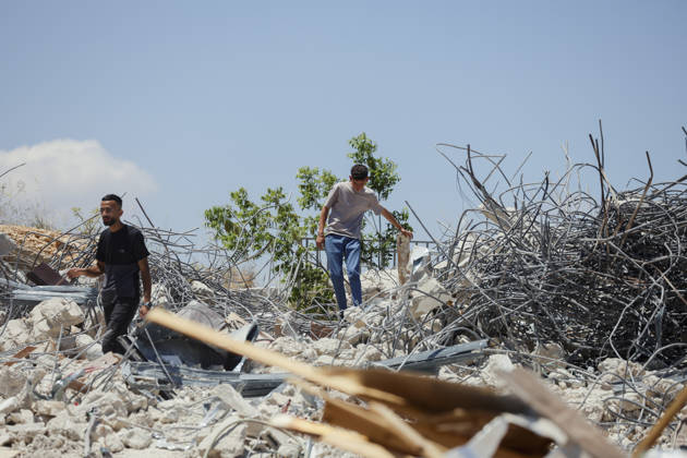 Israeli Demolition West Bank Family Displaced Eid Al-Adha Two men walk across the rubble of a destroyed building in Nahhalin, occupied West Bank, on May 25, 2026. The demolition, carried out by Israeli forces who stated the structure was built without a permit, displaced an eight-member Palestinian family just two days before the Islamic holiday of Eid al-Adha. Bethlehem West Bank Palestinian Territories Copyright: xMosabxShawerx
