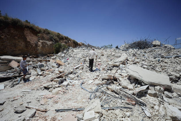 Israeli Demolition West Bank Family Displaced Eid Al-Adha An elderly man and a boy walk across the rubble of a destroyed building in Nahhalin, occupied West Bank, on May 25, 2026. The demolition, carried out by Israeli forces who stated the structure was built without a permit, displaced an eight-member Palestinian family just two days before the Islamic holiday of Eid al-Adha. Bethlehem West Bank Palestinian Territories Copyright: xMosabxShawerx