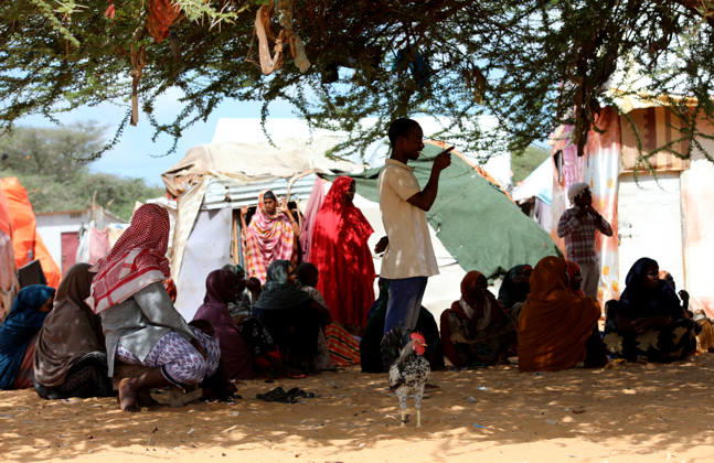 Camps turn into permanent settlements amid ongoing crisis in Somalia MOGADISHU, SOMALIA - MAY 26: People spend time in the shadow of a tree as millions of people living in camps that have gradually turned into permanent settlements, where they continue to face difficult living conditions amid insecurity, conflict and drought in the capital Mogadishu, Somalia, on May 26, 2026. Metin Yuksel Kaya Anadolu Mogadishu Somalia. Editorial use only. Please get in touch for any other usage.  Copyright: x2026xAnadoluxMetinxYukselxKayax