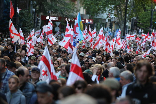 Anti-government protest in Tbilisi TBILISI, GEORGIA - MAY 26: Pro-EU demonstrators wave national flags of Georgia, the European Union, the United States, and Ukraine during an anti-government protest rally outside the Parliament Building on Rustaveli Avenue in Tbilisi, Georgia on May 26, 2026. Organized by the Opposition Alliance , a coalition of various pro-Western opposition political parties, the peaceful demonstration began in the evening hours outside the main entrance of Ivane Javakhishvili Tbilisi State University before marching through the central streets of the capital. Thousands of participants chanted anti-government slogans and accused the ruling party of executing ineffective foreign policies that threaten to derail Georgia s  Copyright: x2026xAnadoluxDavitxKachkachishvilix