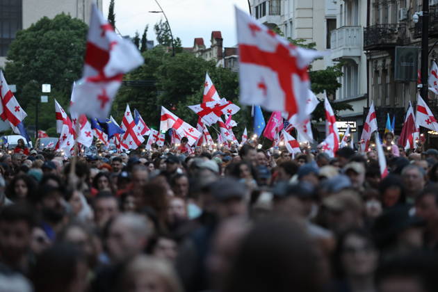 Anti-government protest in Tbilisi TBILISI, GEORGIA - MAY 26: Pro-EU demonstrators wave national flags of Georgia, the European Union, the United States, and Ukraine during an anti-government protest rally outside the Parliament Building on Rustaveli Avenue in Tbilisi, Georgia on May 26, 2026. Organized by the Opposition Alliance , a coalition of various pro-Western opposition political parties, the peaceful demonstration began in the evening hours outside the main entrance of Ivane Javakhishvili Tbilisi State University before marching through the central streets of the capital. Thousands of participants chanted anti-government slogans and accused the ruling party of executing ineffective foreign policies that threaten to derail Georgia s  Copyright: x2026xAnadoluxDavitxKachkachishvilix