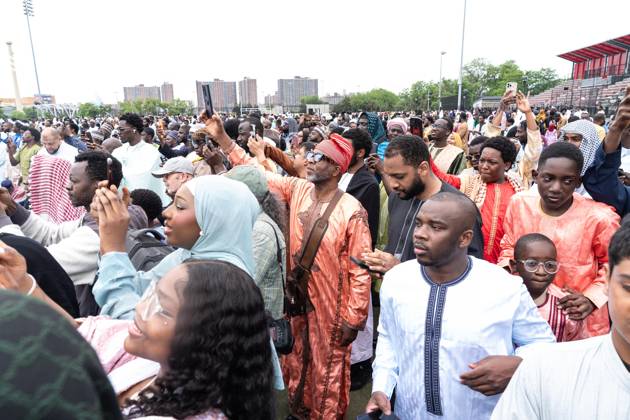 May 27, 2026, New York, New York, USA: People listen to and recording on cell phones as Mayor Zohran Mamdani delivers remarks during Eid Al-Adha holiday prayers at The Yancy Track & Field in New York, NY on May 27, 2026. Hundreds of men, women and children attended wearing clean, colorful and expensive traditional clothes. Eid al-Adha translates from Arabic to Festival of Sacrifice is one of the most important holidays in the Islamic calendar. It honors the Prophet Ibrahim s (Abraham s in Judaism) absolute obedience to God, commemorating his willingness to sacrifice his son as an act of submission before God provided a ram to sacrifice instead. New York USA  - ZUMAr339 20260527_znp_r339_010 Copyright: xLevxRadinx