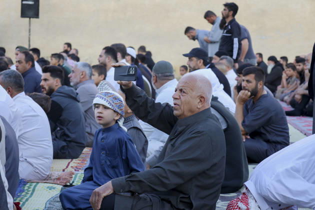 Eid Al-Adha Prayers Idlib An elderly man holds a mobile phone while sitting with others on prayer rugs before Eid al-Adha prayers in Idlib, Syria, on May 27, 2026. Eid al-Adha, or the Feast of Sacrifice, is one of the most important holidays in the Islamic calendar, commemorating the willingness of Prophet Ibrahim to sacrifice his son. The event is traditionally marked worldwide by communal prayers, family gatherings, acts of charity, and the slaughtering of livestock. Idlib Idlib Syria Copyright: xOmarxAlbawx