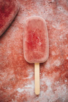 Raspberry popsicle on a red background Raspberry popsicle on a red background Copyright: xClaudiaxSilverstonex CS160426-3